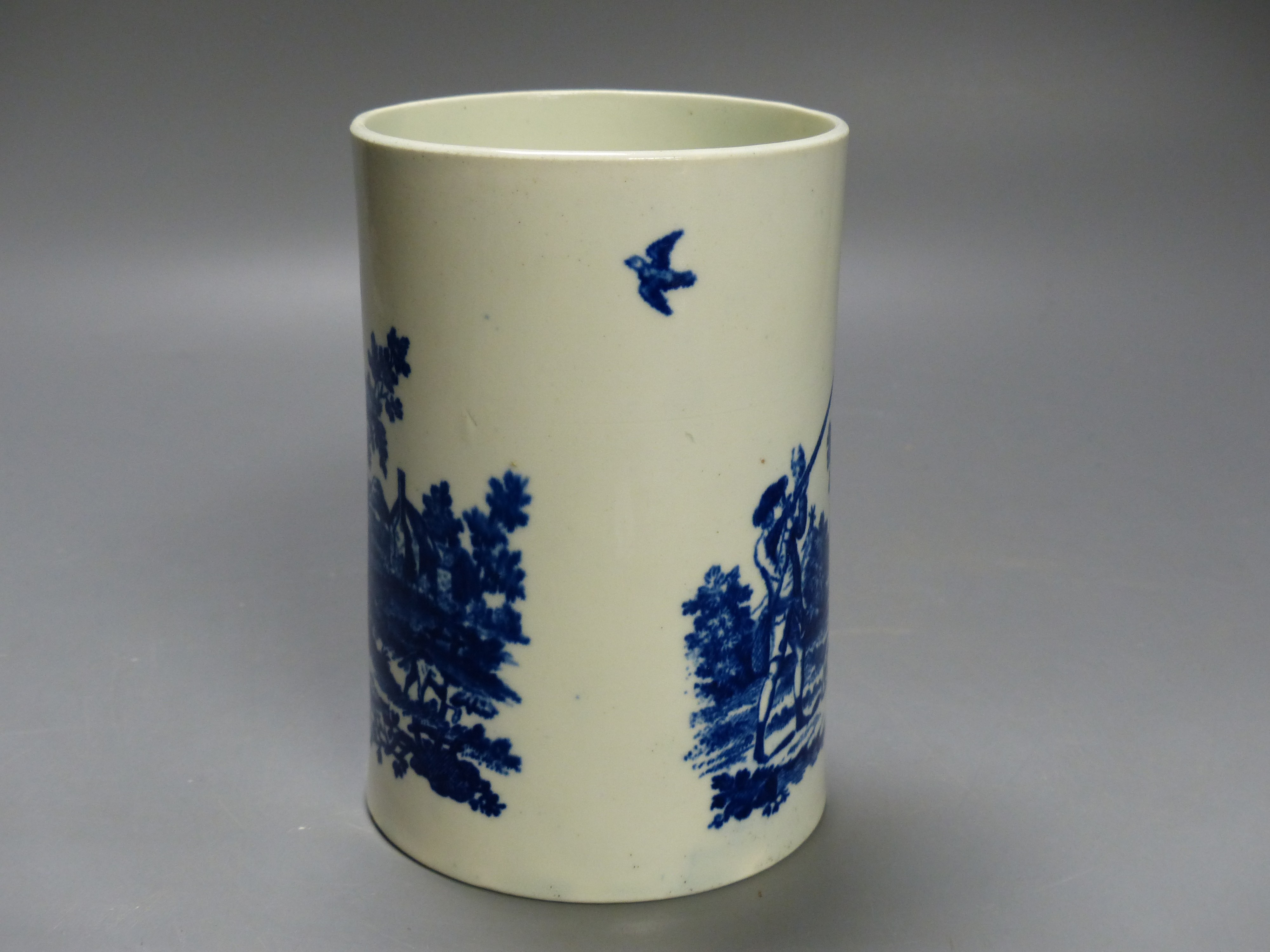 A Worcester 'Man holding gun' and 'Man shooting gun' patterns cylinder mug. Printed, shaded crescent mark, height 14cm